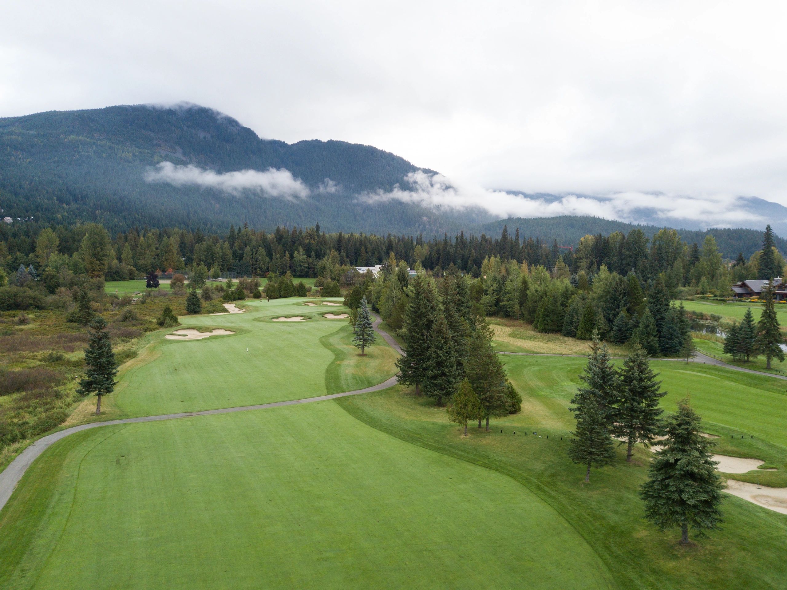Aerial view over a golf course fairway at sunrise