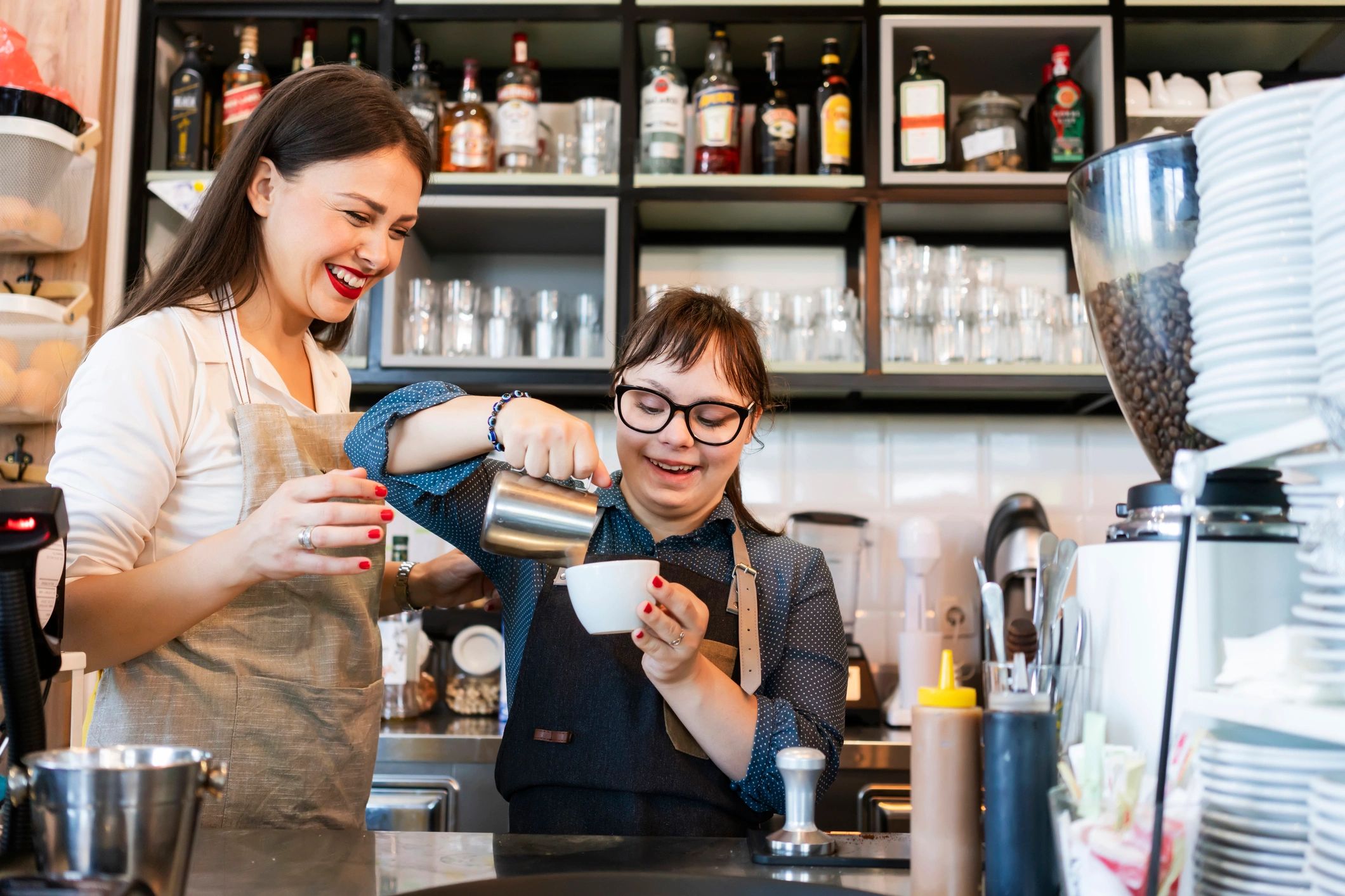 Woman with Down syndrome working at a cafe preparing coffee