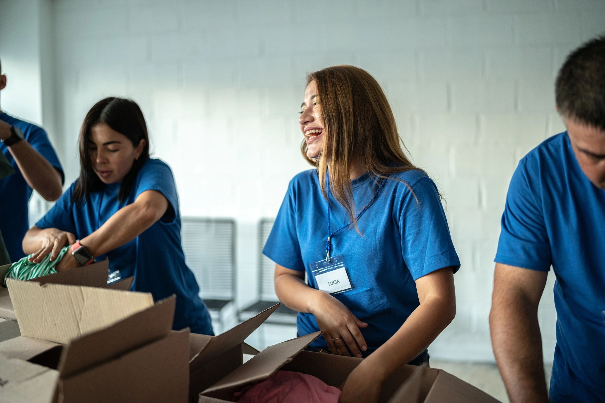 Volunteer smiling while organizing a donation box