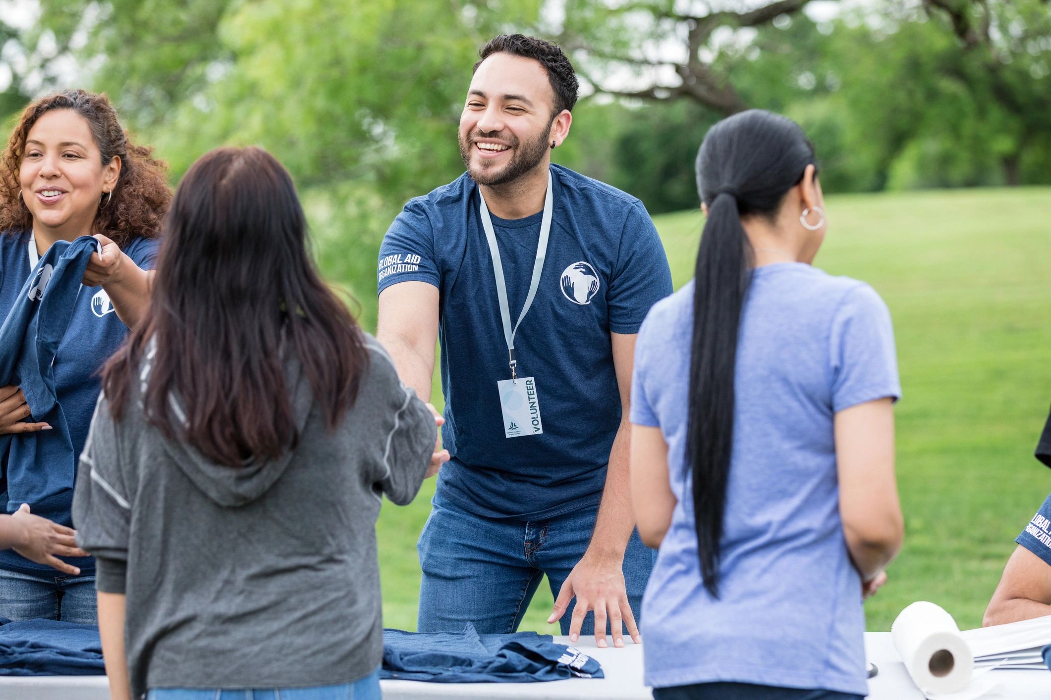 Volunteer greeting a participant at a community event