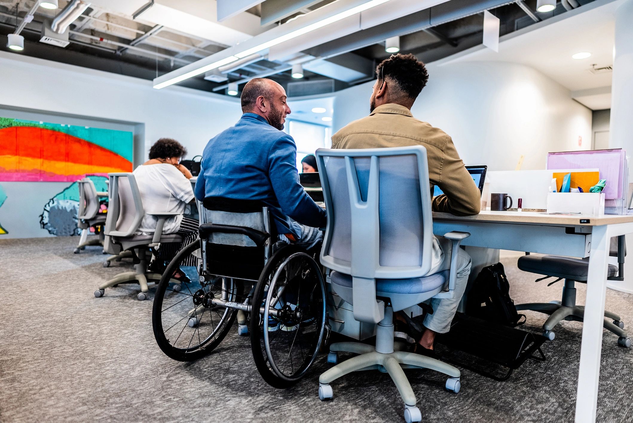 Coworkers including a wheelchair user collaborating in a meeting