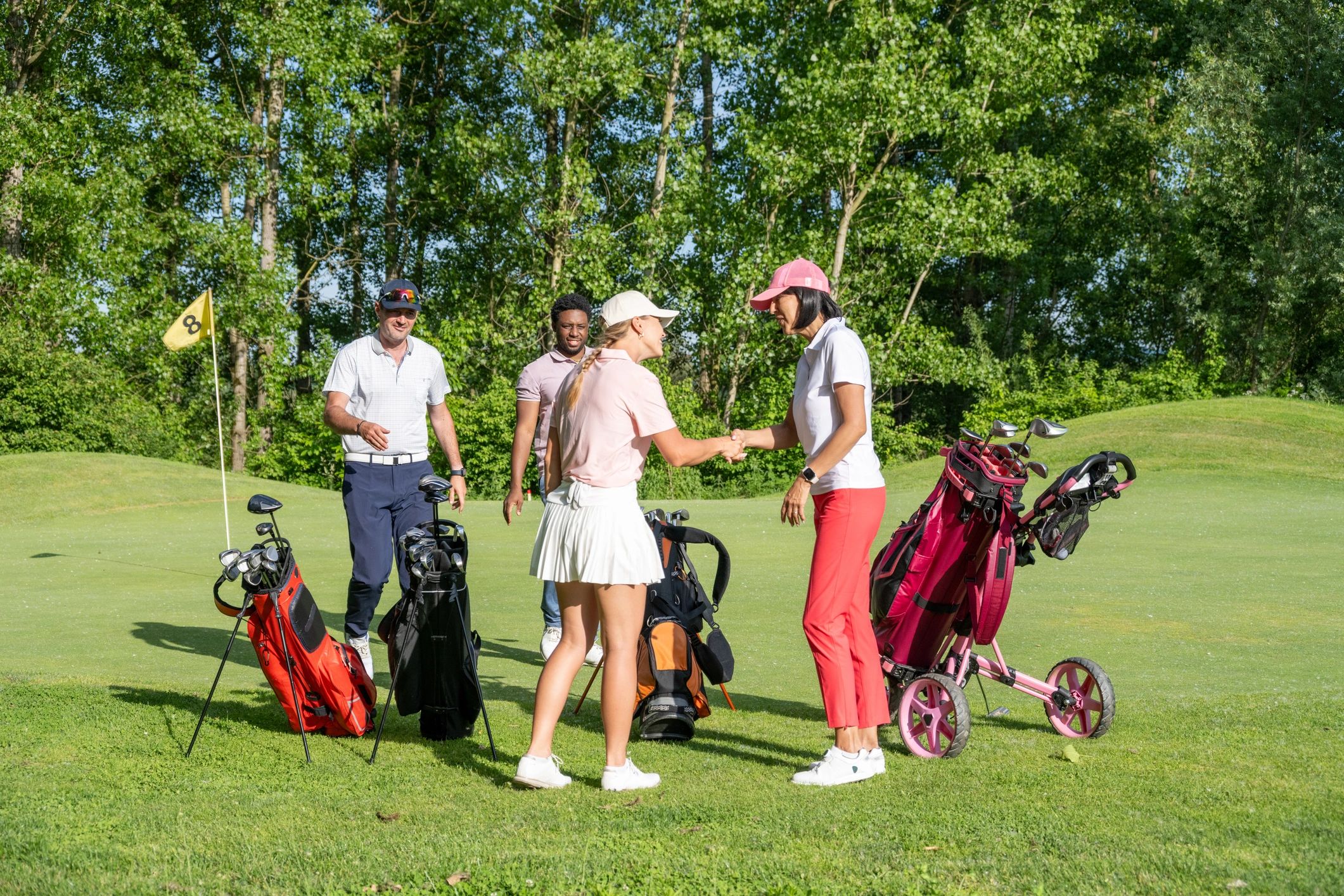 Golfers enjoying a friendly moment on a sunny course