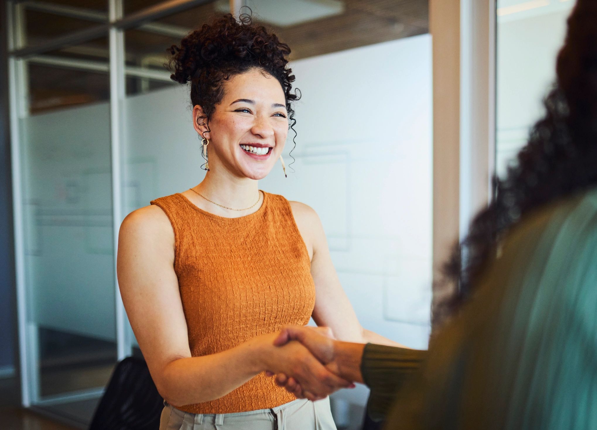 Business partnership handshake in an office