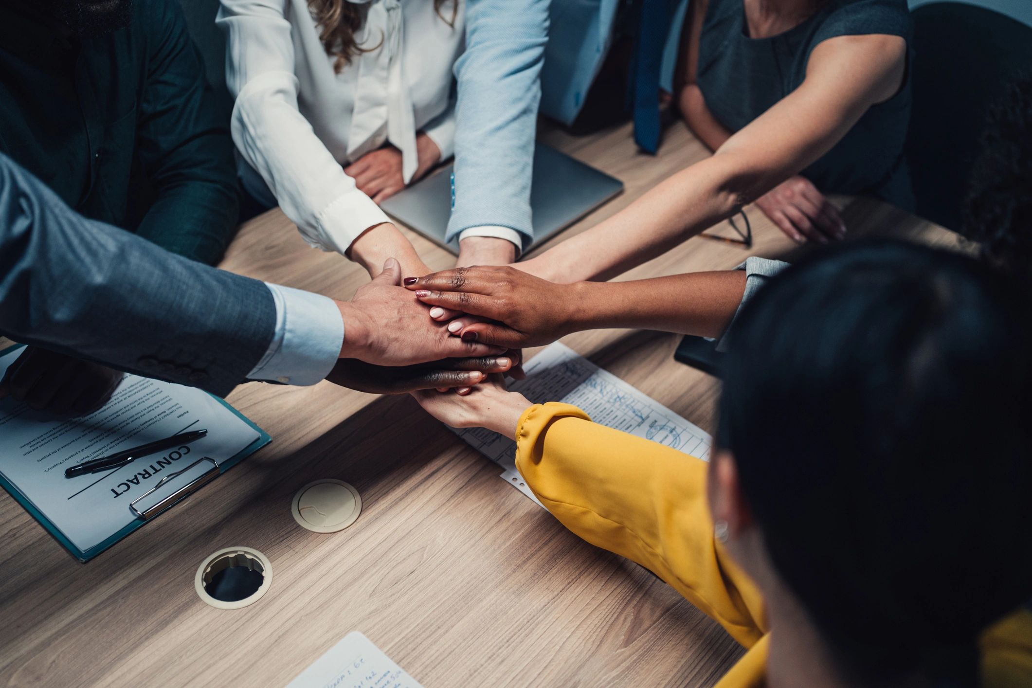 Group hands stacked together in teamwork